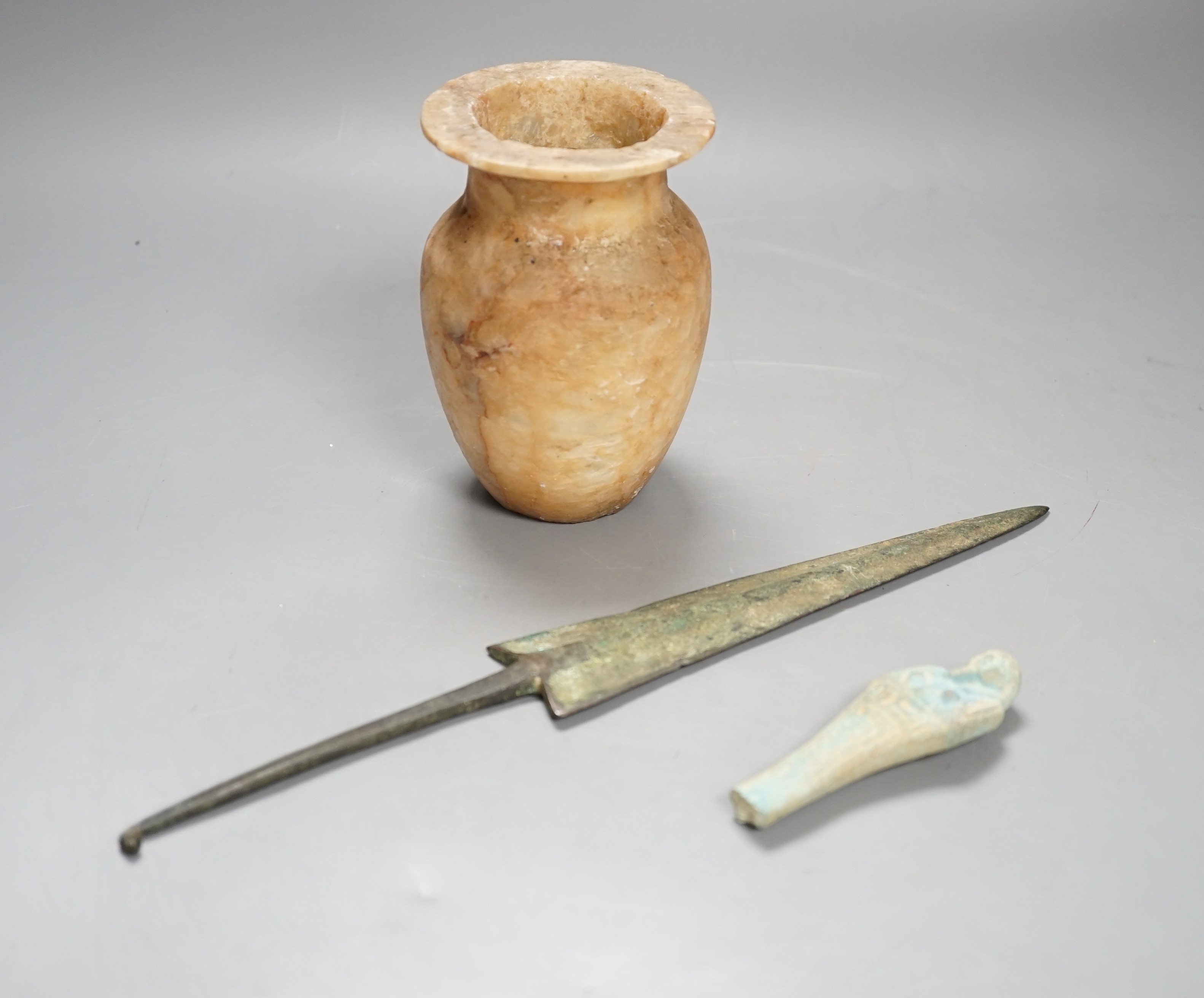 Antiquities to include a Luristan bronze spear head, an Egyptian ushabti (af) and an alabaster jar, spear head 30.5cm long